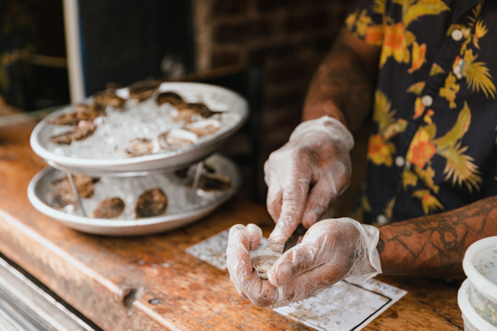 Shucking oysters at a seafood bar