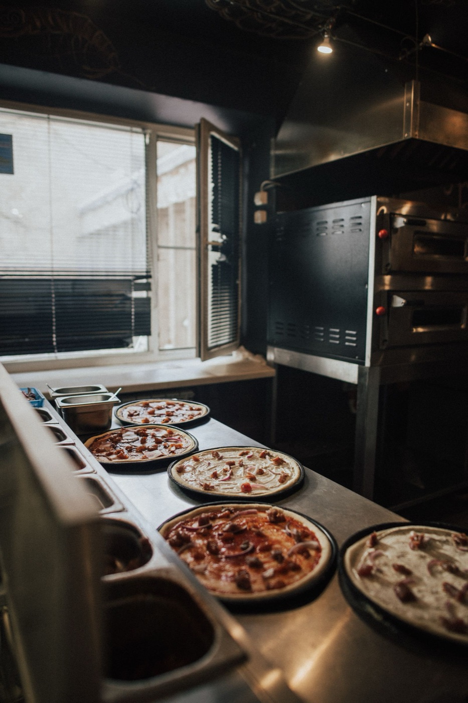 Pizzas boxed for delivery in a restaurant kitchen