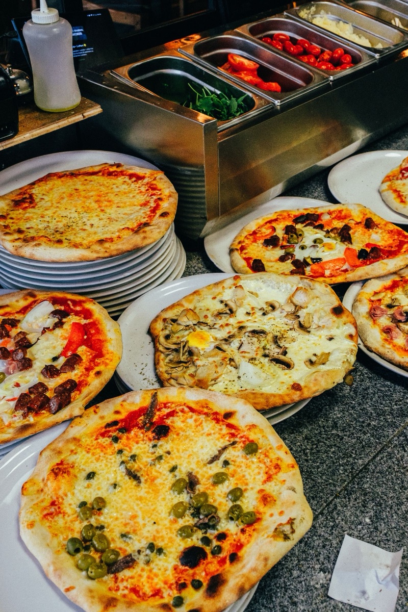 Assorted pizzas displayed in a restaurant